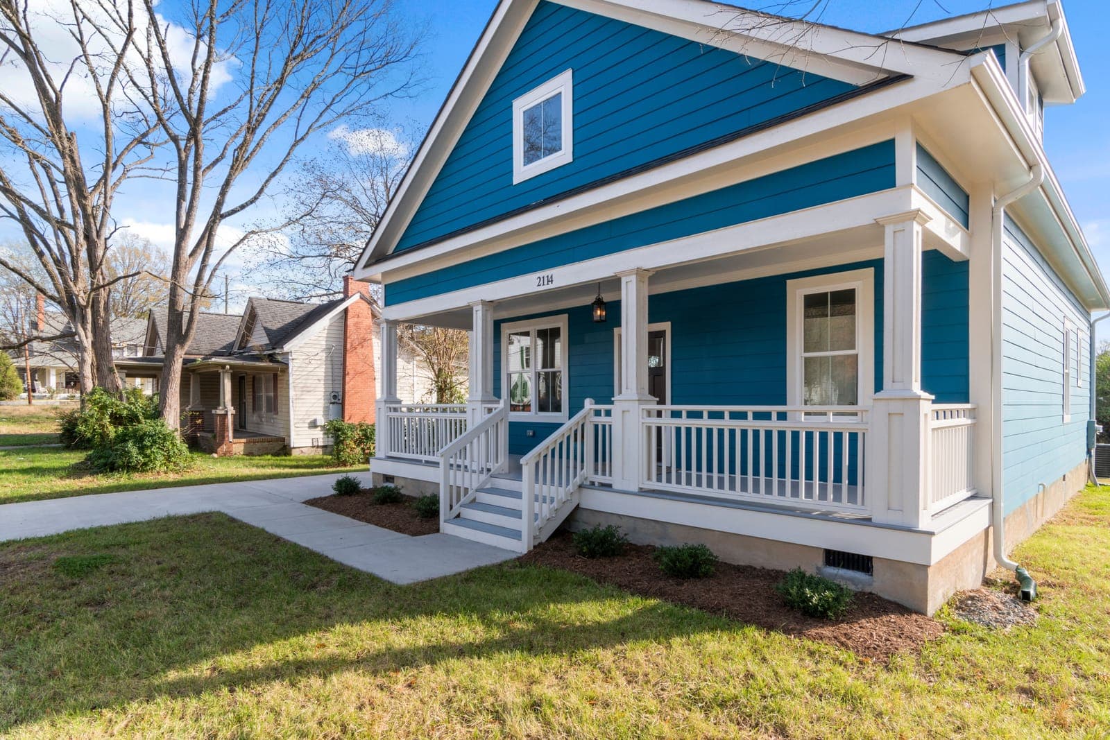 Craftsman home with a freshly painted blue exterior and white trim